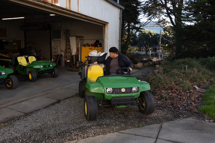 Grounds Department employee Pete Gi backing up his utility vehicle on Ocean Campus.