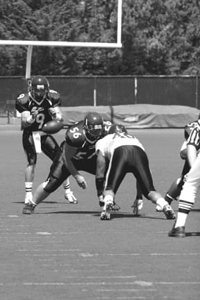 Offensive lineman Martin Falk (56) blocks a Cabrillo College defensive lineman after he snaps the ball to quarterback Chris Forni (90) during the season opener Sept. 6. ANNE-MARIE STARK / GUARDSMAN
