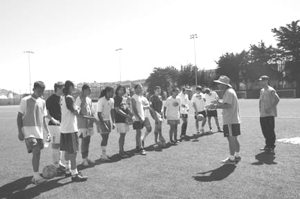 soccerplay2 Coach Lucarelli instructs the team during practice.