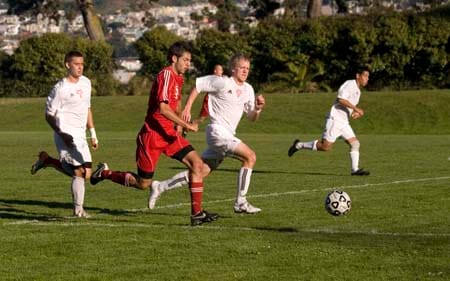 Soccer_11_4_09 Allen LaSpina and Las Positas Hawk's players race in an attempt to recapture possession of the ball. TRISTAN CRANE / THE GUARDSMAN