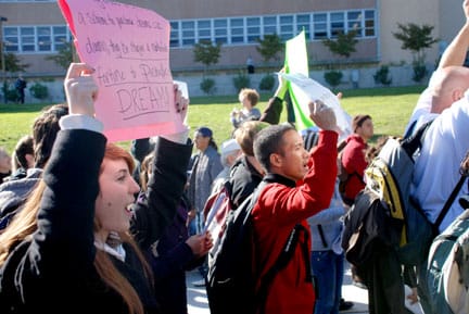 DSC_1590 Katie Dalla (left), part of a crowd of about 200, marches around Cloud Circle during the City College budget cuts walkout on Nov. 18. The march ended with a protest at Conlan Hall.