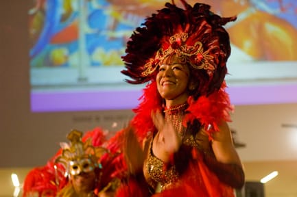 An elaborately costumed dancer perfoms the Colombian aerobic dance Zumba by Jaime Martinez of Latin American Workout during a Carnaval celebration at the de Young Feb. 5. The performance is part of Cultural Encounters: Friday Nights at the de Young, a series of events combining performing and visual artists with community arts organizations. CHLOE ASHCRAFT / THE GUARDSMAN