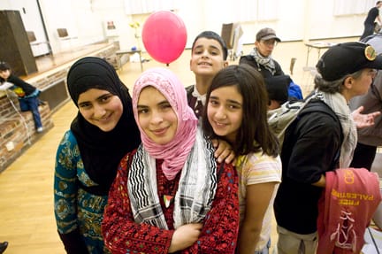 Palestinian refugee and poet Mariam El Shafei (center) stands with her host family (L-R) Halima Shuman, Mouté Shuman and Rasmia Shuman at the Gaza Massacre Commemoration Feb. 6 at the Burlingame Recreation Center. ROBERT ROMANO / THE GUARDSMAN