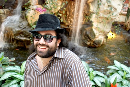Reporter Greg Zeman takes a moment to enjoy the scenery inside the lobby of the Embassy Suites Hotel San Francisco Airport. RAMSEY EL-QARE / THE GUARDSMAN