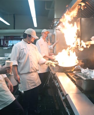 Third semester Culinary Arts major Victor Vargus prepares a dish at the new Noodle Room as fellow major Kyle Meadows looks on, Feb 26. CHLOE ASHCRAFT / THE GUARDSMAN