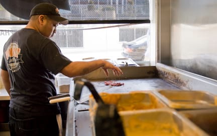 phat phillys-4_ONLINE Phat Philly employee Miguel Poot prepares some beef for a sandwich on the grill at the 24th and Valencia St. restaurant on March 14. CHLOE ASHCRAFT / THE GUARDSMAN