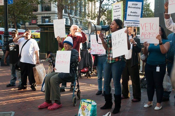 A group of more than 20 students and teachers from all over San Francisco Bay Area gather to rally against AB955 near Powell Street BART. Shanell Williams, 29, center, City College of San Francisco Student Trustee, takes the bullhorn and speaks to the crowd during the protest demanding that Governor Jerry Brown vetos AB955. “I wanted him to know that he should veto the bill,” Williams says, “low income students will have a hard time to access classes.” San Francisco, California. September 24, 2013. Photo by Ekevara Kitpowsong/The Guardsman