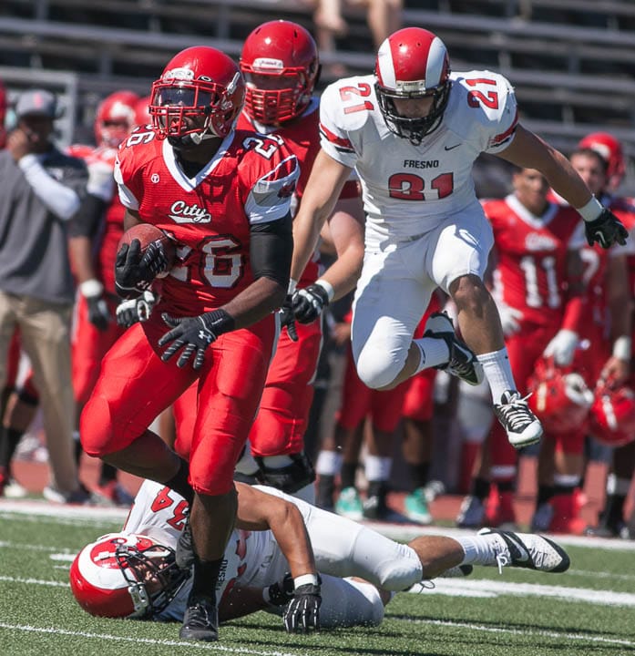 San Francisco Rams running back Jahray Hayes (26) brakes Fresno Rams Mark Dillard (34) tackle and runs the ball 34 yards for a touchdown on Saturday, Sept. 28, 2013, at Ocean campus. Photo by Santiago Mejia/The Guardsman