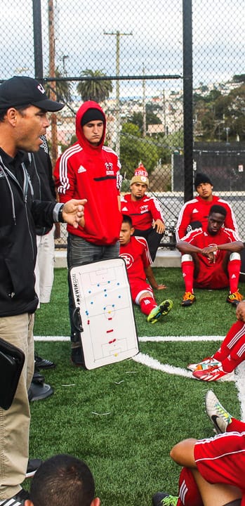 City College’s men’s soccer head coach Adam Lucarelli instructs his players during  halftime at the Rams’ soccer field on Ocean campus Sept. 20, 2013. Photo by Lucas Almeida/The Guardsman