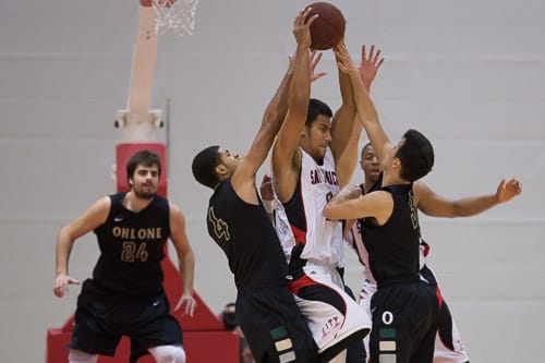 San Francisco Rams sophomore guard Joshua Fox (21) is defended by the Ohlone College Renegades in a CCCAA men’s basketball game on Ocean campus, Friday, Feb. 22, 2014. The Rams won the game 71-63, finishing the regular season 12-0 undefeated. They won the Coast-North Conference title and will compete in playoffs next week. Photo by Santiago Mejia/The Guardsman
