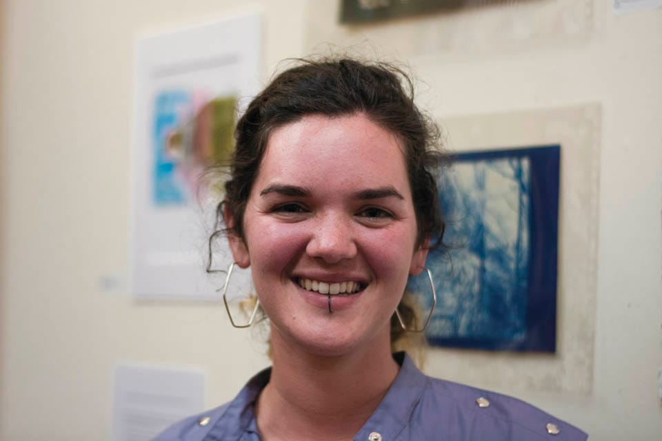 Briana Shewan, co-organizer of CCSF Mixed Media Art exhibit, celebrates at the opening reception on Thursday, Sept. 11, at Modern Times Bookstore in San Francisco’s Mission District. (Photo by Niko Plagakis)
