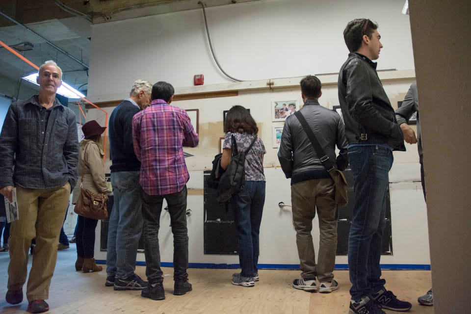 People gather to view works by Inks of truth at the San Francisco Barber College on 6th Street in San Francisco as part of the 2 Blocks Art Walk on Friday, Oct. 10. (Photo By: Niko Plagakis) 