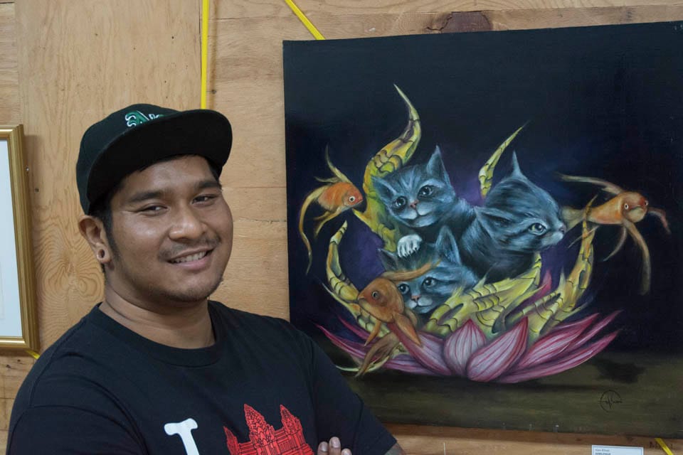 Alan Khum, San Francisco resident, artist and collaborator with Inks of Truth, stands in front of one of his pieces on display as part of the 2 Blocks Art Walk at the old San Francisco Barber College located at 64 6th Street, San Francisco. “This is my second time showing my work with Inks of Truth,” He stated on Friday, Oct. 10. (Photo By: Niko Plagakis)