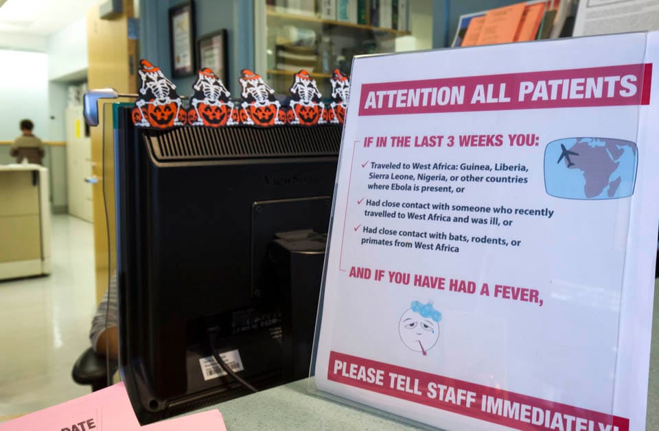 At the reception desk of The Student Health Center sits a sign that asks students to consider three key warnings that could mean an infection of Ebola.  (Photo by Nathaniel Y. Downes, October 27, 2014)