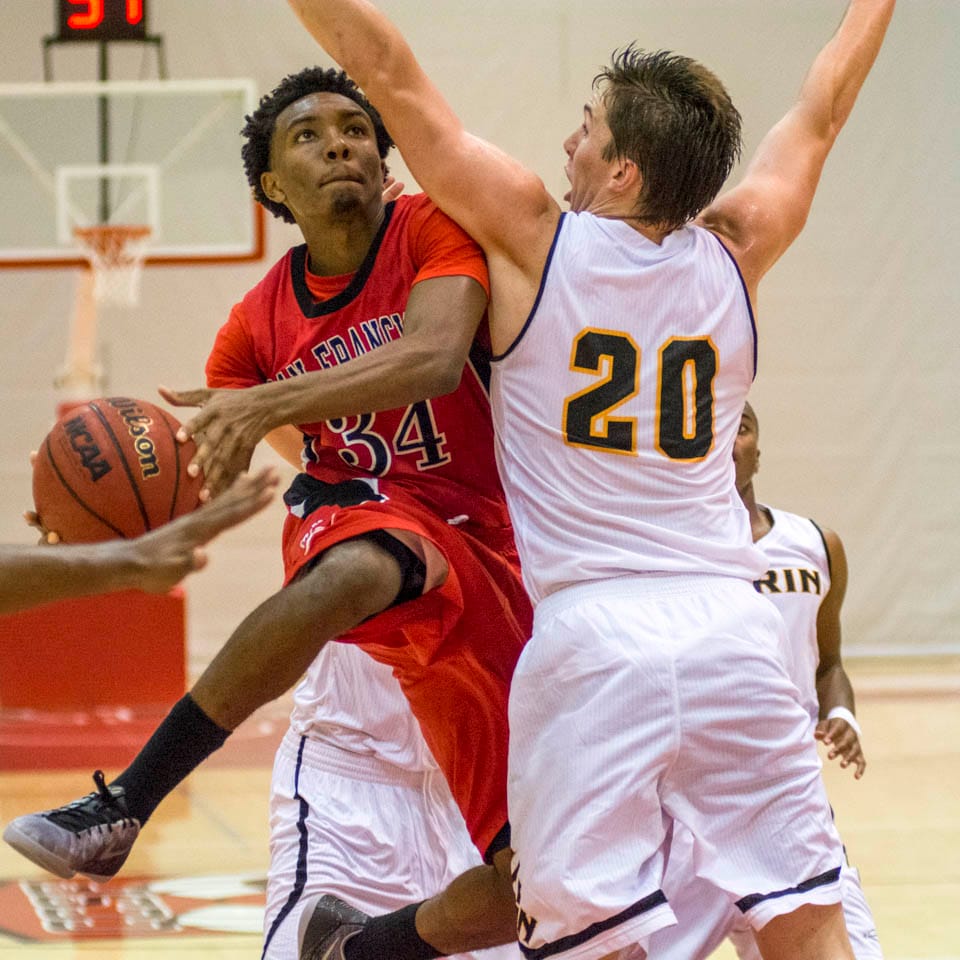 Troy Thompson #34, attempts to jump past a College of Marin defender for a layup during Friday night’s home game at City College on Nov. 7. (Photo by Niko Plagakis)