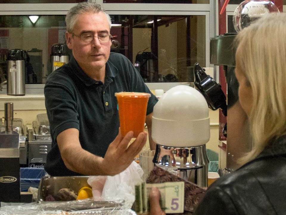 Alberto Campos delivers a drink at Cafe de la Mission ( Photo by Niko Plagakis)