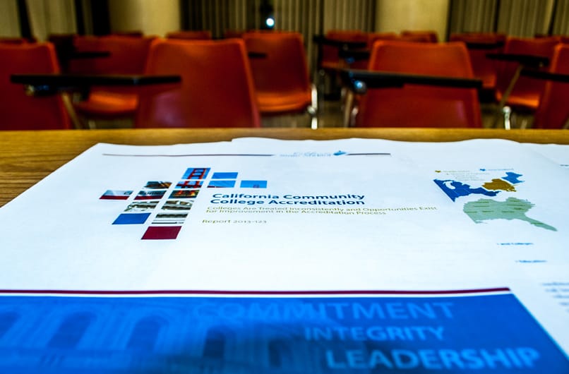 Pages from the state auditor’s report sit on the counter of the downtown campus bookstore Jan. 13, 2015. The 74-page report released June 2014 states the accreditation commission was inconsistent, lacked transparency and could have allowed the school more time to address issues. (Photo by Patrick Tamayo)