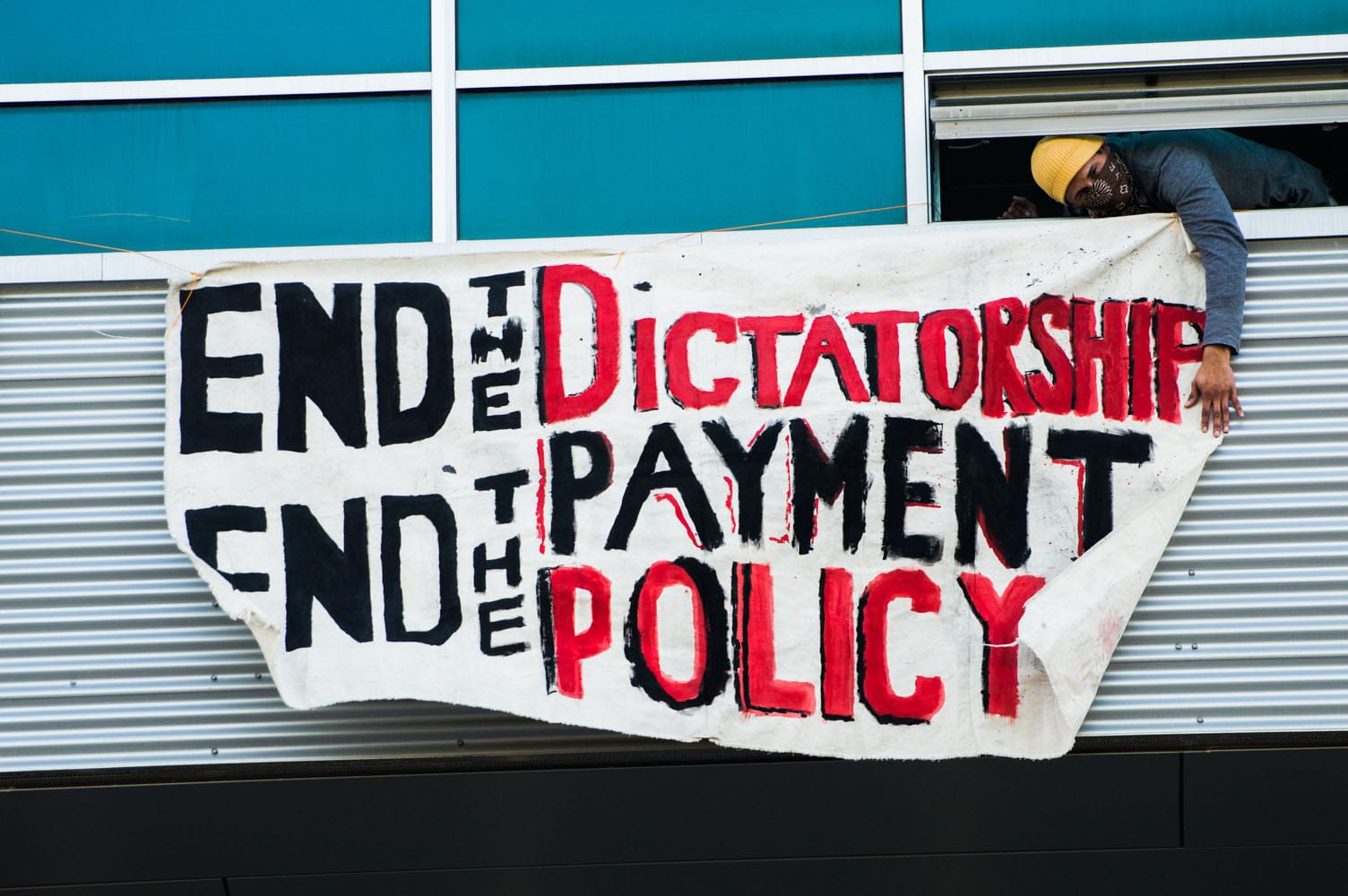 Student Organizer Lalo Gonzales from MeChXA De CCSF calls for the end of Special Trustee Robert Agrella and the restoration of the elected Board of Trustees on Thursday, Jan. 22 at Multi-Use Building on Ocean Campus. (Photo by Bridgid Skiba)