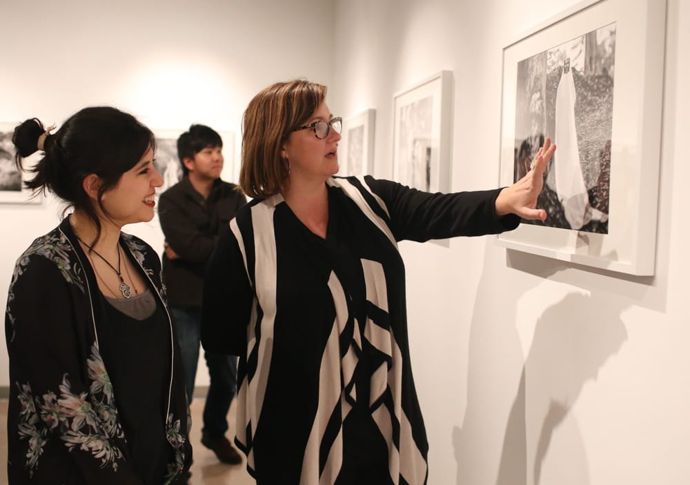 Amanda Aceves, left, and Photography Department Chair, Erika Gentry, right, view the photographs displayed during the opening reception of “Dreamscapes,” exhibition by Amanda Aceves at Gallery Obscura at Ocean Campus, Monday, Feb. 9. (Photo by Natasha Dangond)