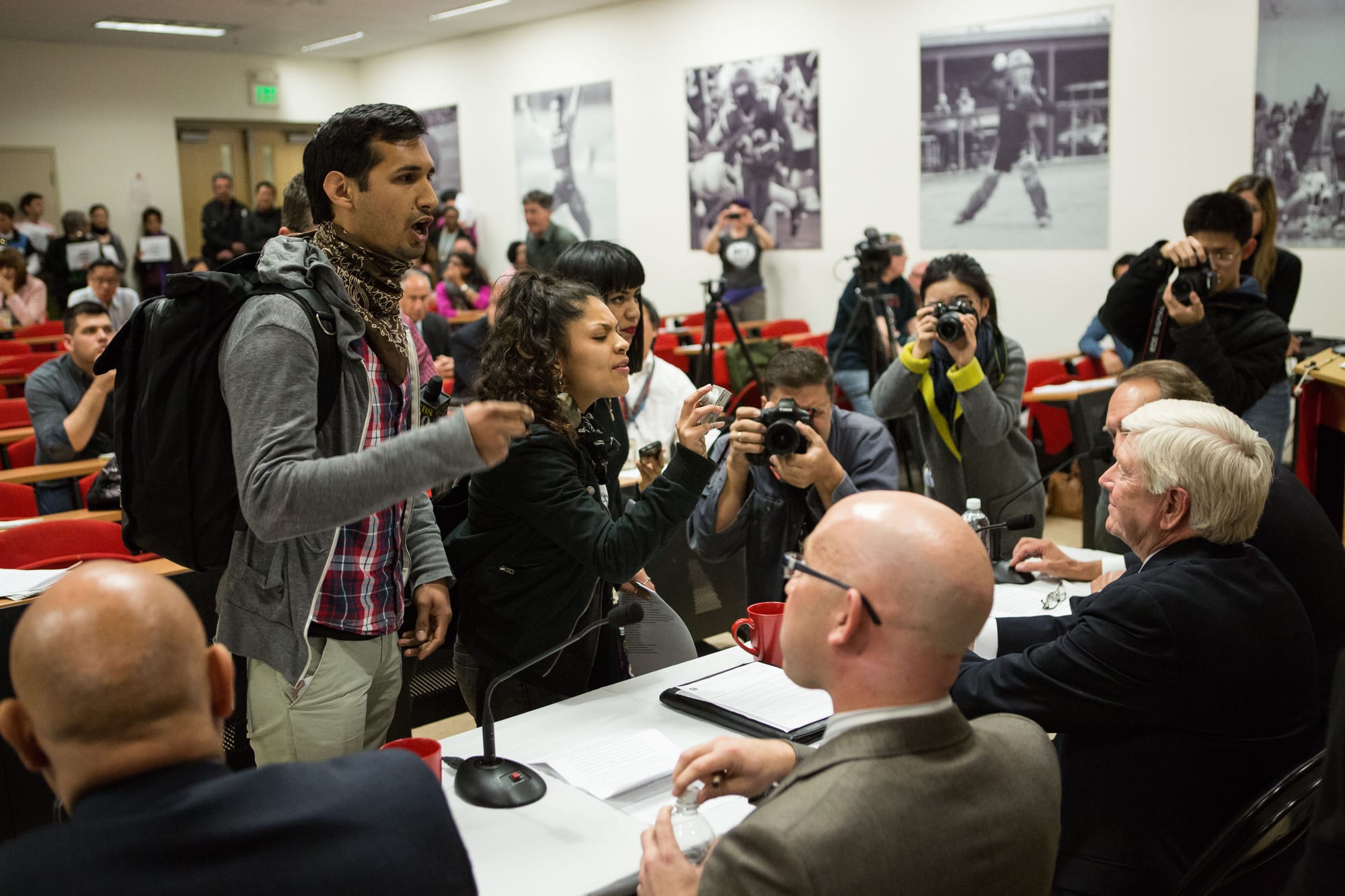 (L-R) Lalo Gonzales, president of MECHxA and three City College students, Alondra Aragon, Itzel Cminth and Imiry Rizas protest in front of the Chancellor Dr. Arthur Tyler, Board of Trustees President Rafael Mandelman, Dr. Guy Lease the new special trustee and State Chan- cellor Dr. Brice Harris, during a press conference in Room 103 at the Wellness Center on Monday, Feb. 23. (Photo by Khaled Sayed)