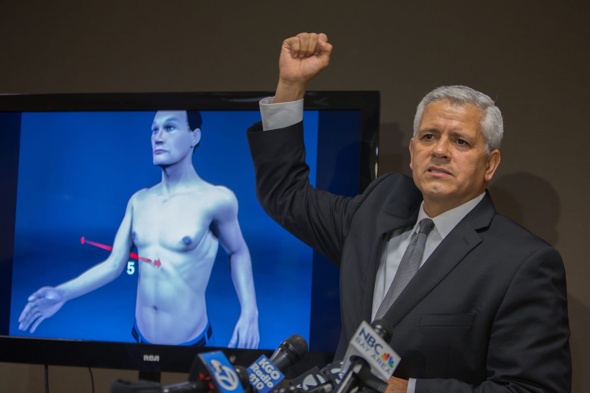 Arnaldo Casillas, Amilcar Perez-Lopez's attorney, showing crime scene and autopsy evidence at a news conference April 25, 2015 San Francisco, CA ( photo by Khaled Sayed)