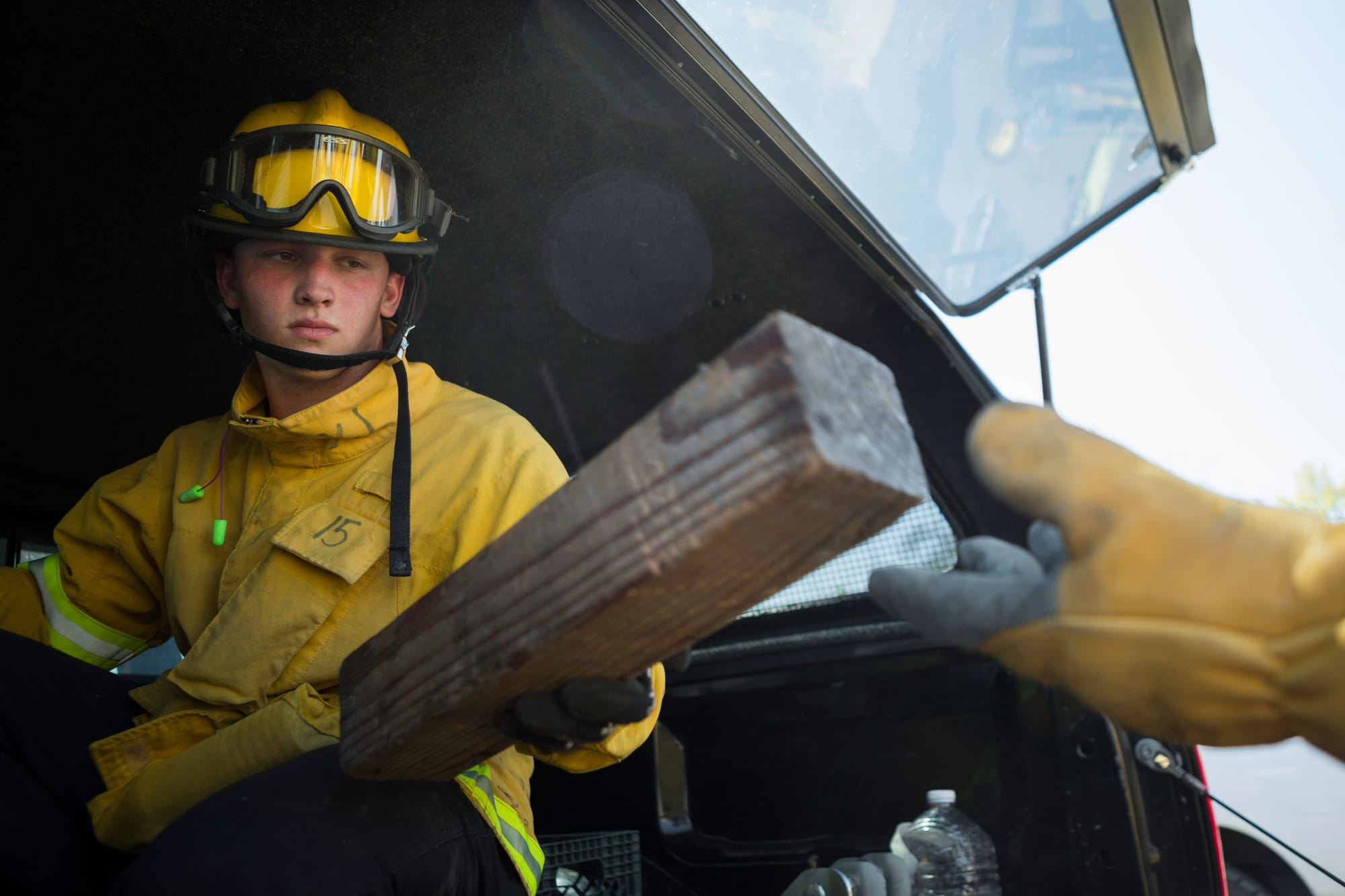 Fire cadet Nick Oatley from City College’s Fire Fighter One Academy’s Class 15 passes a cribbing used to stabilize and unstable car during the auto extrication training at San Jose Pick and Pull on Saturday, April 18, 2015. (Photo by Nathaniel Y. Downes/The Guardsman)