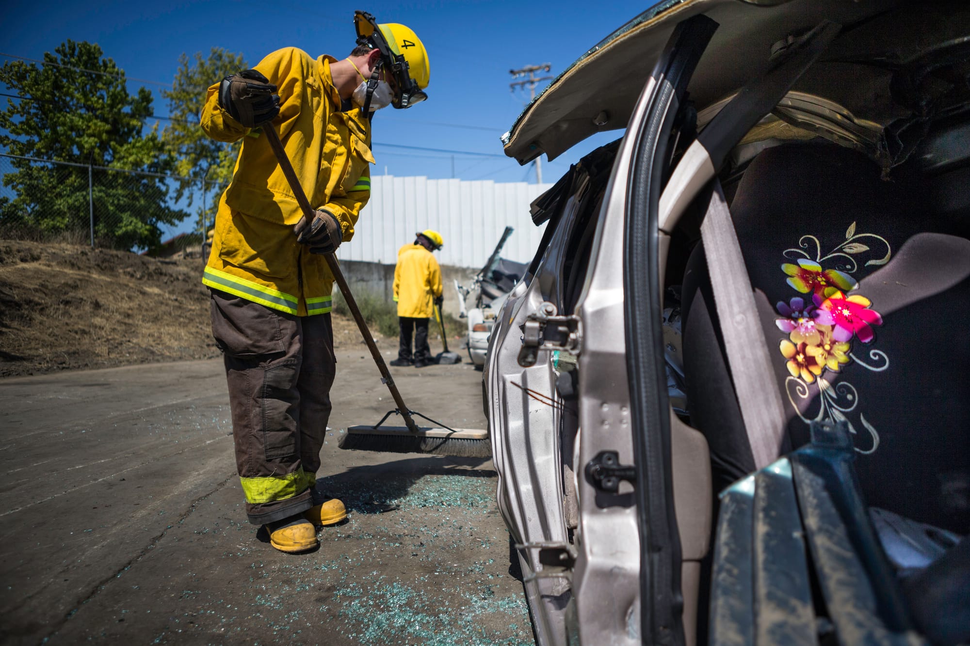 Fire cadet William Scott Cowell from City College’s Fire Fighter One Academy’s Class 15 cleans up the yard after practicing auto extrication techniques at San Jose Pick and Pull on Saturday, April 18, 2015. (Photo by Nathaniel Y. Downes/The Guardsman)