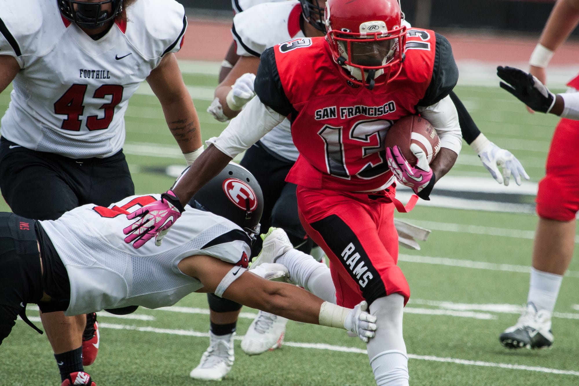 Rams running back Namane Modise (13) breaks through Foothill College defense on the 20th yard at Rams Stadium on Saturday, Oct. 17. (Photo by Khaled Sayed/The Guardsman)