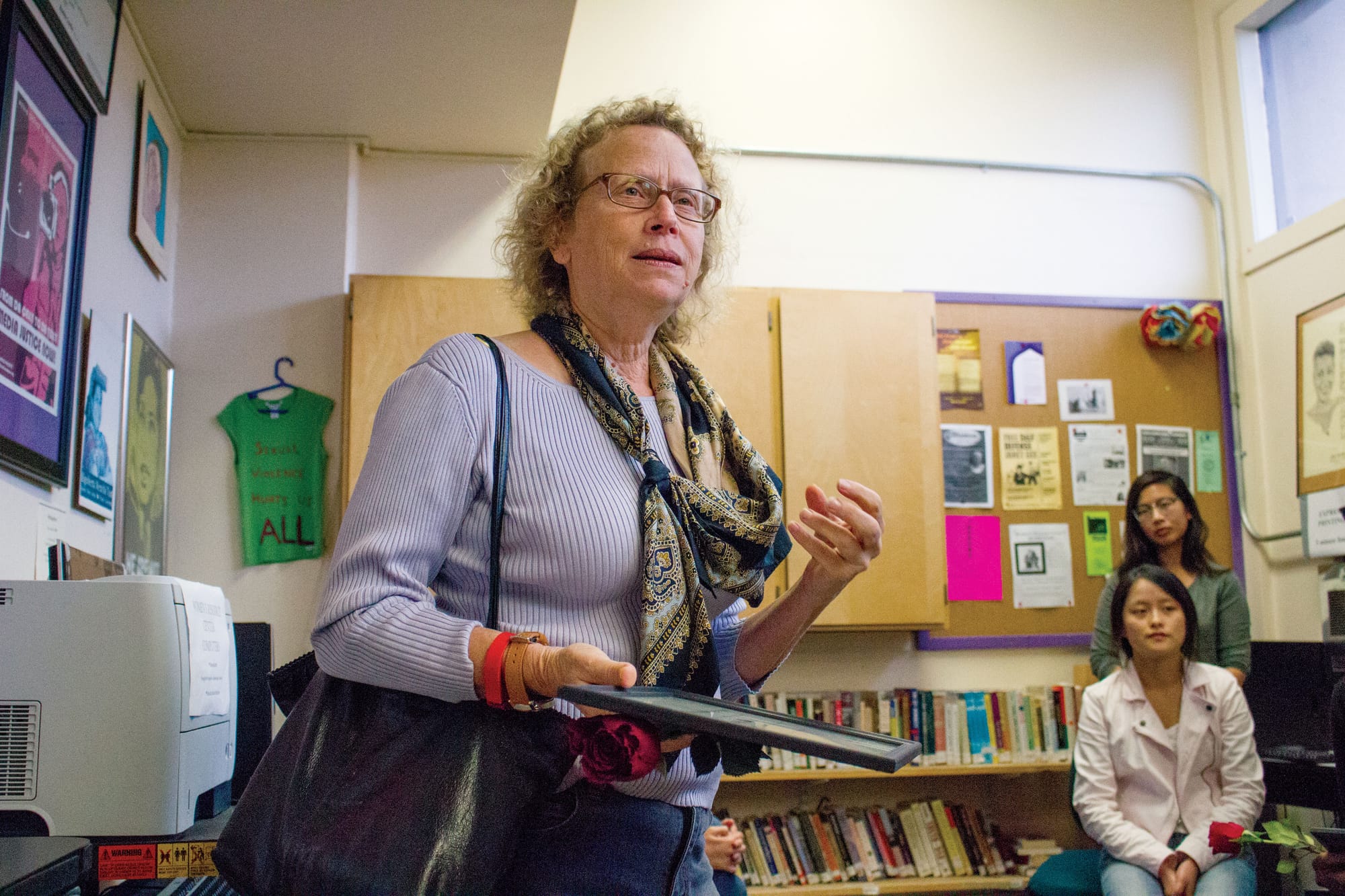 Interdisciplinary Studies Department Chair Lauren Muller offers words of encouragement as she accepts a commendation from the Women’s Resource Center staff in thanks for her service to the organization. (Photo by Shannon Cole/The Guardsman)