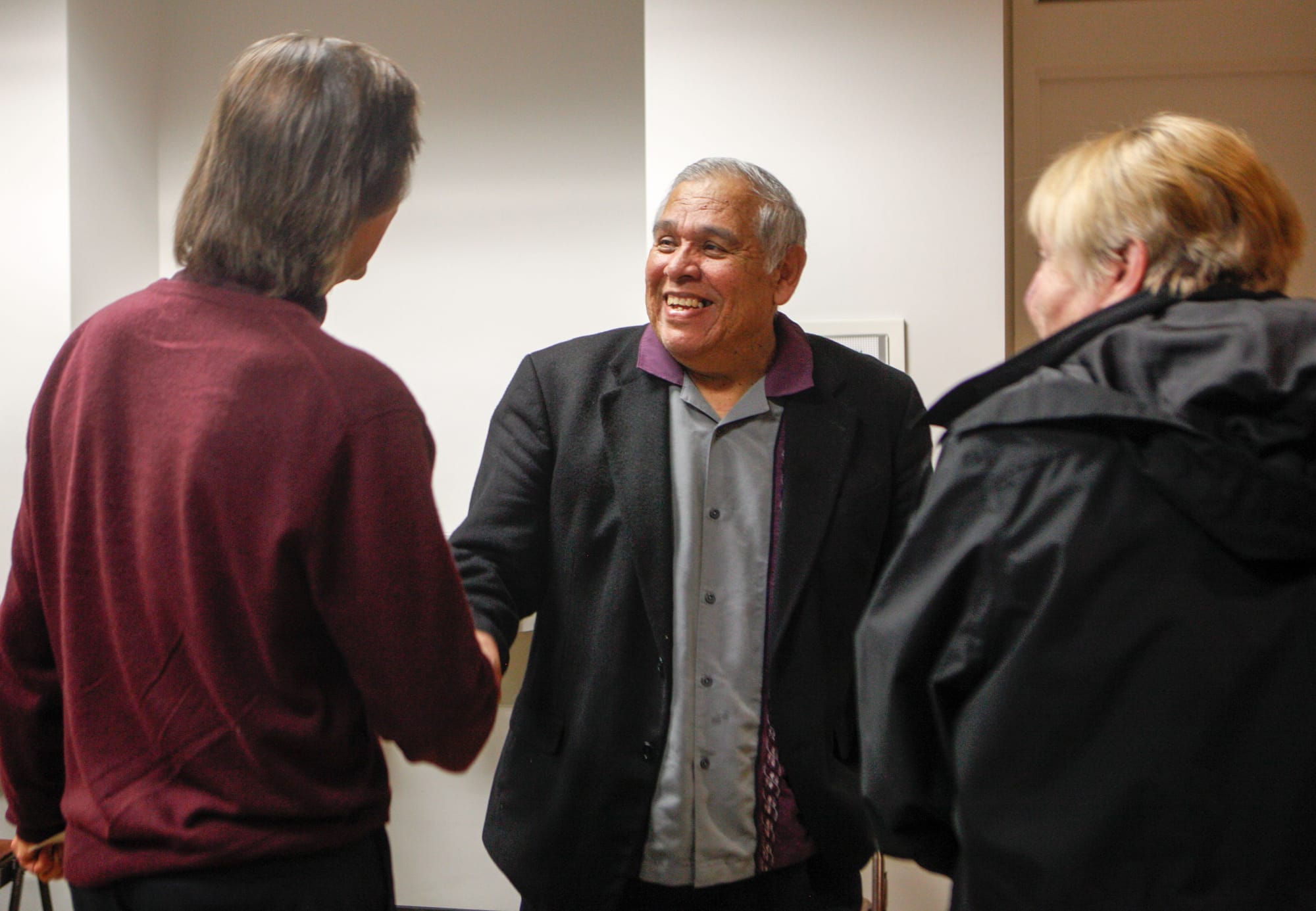 Journalism department chair and The Guardsman advisor, Juan Gonzales, greets guests, left, ESL instructor Victor Turks and retired CCSF librarian Julia Bergman, right, at the 80th Anniversary celebration of the colleges newspaper on November 12, 2015 at the Louise & Claude Rosenberg, Jr. Library. (Photo by Franchon Smith/The Guardsman)