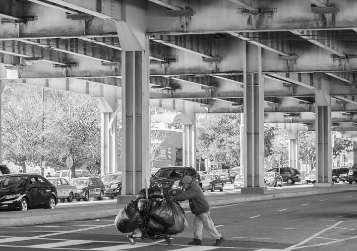 A man from the Division Street homeless encampment relocates after being kicked out on March 1. The in- habitants were given a notice a week earlier to clear the area after a health inspector deemed the tent city a health hazard. The encampment was home to scores of homeless people who took advantage of the freeway protecting them from weather conditions. (Photo by Santiago Mejia/The Guardsman)