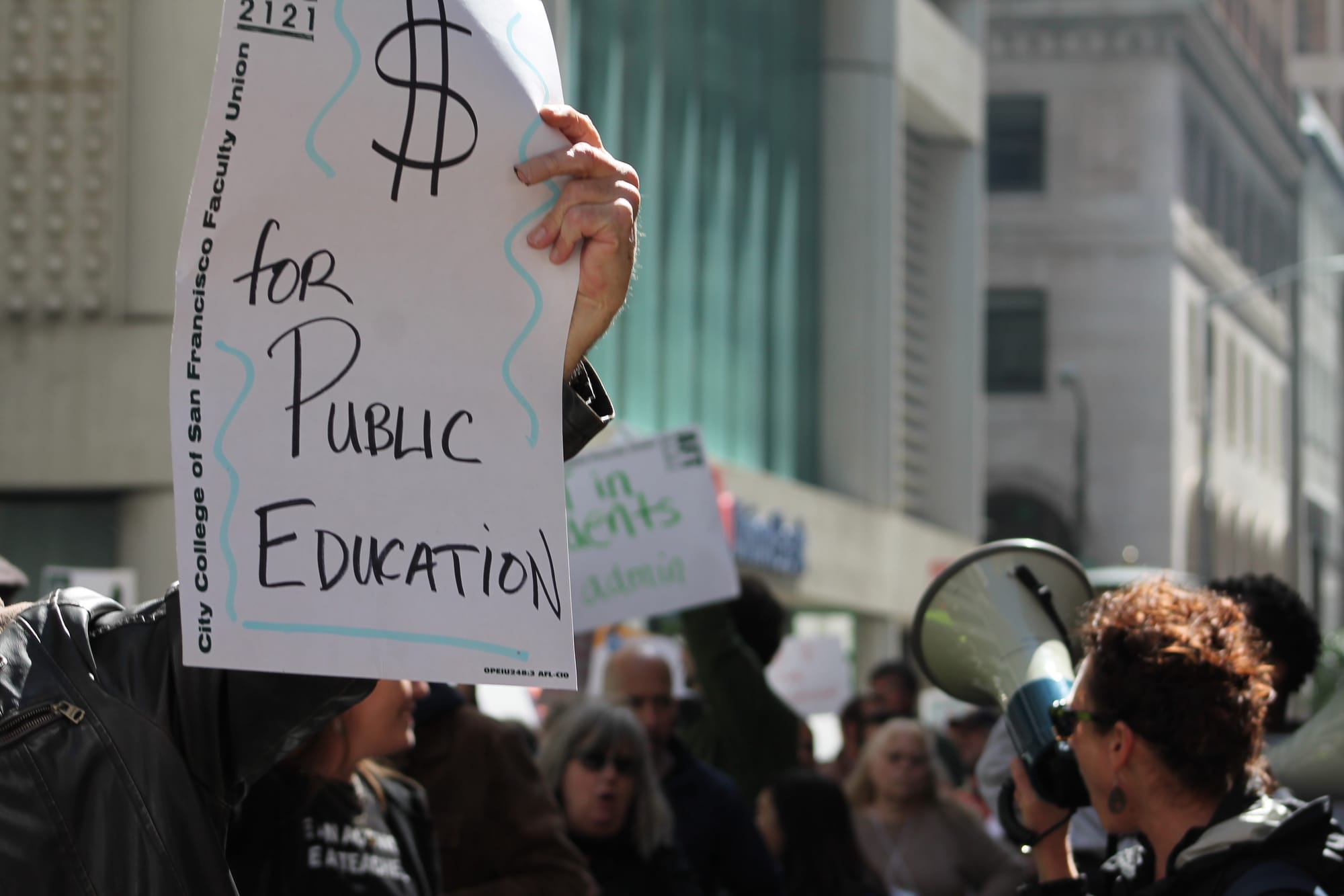A group of protesters march through the middle of the street downtown as police block traffic, chanting demands for more money put toward the funding of public education on March 11, 2016. (Audrey Garces/The Guardsman)