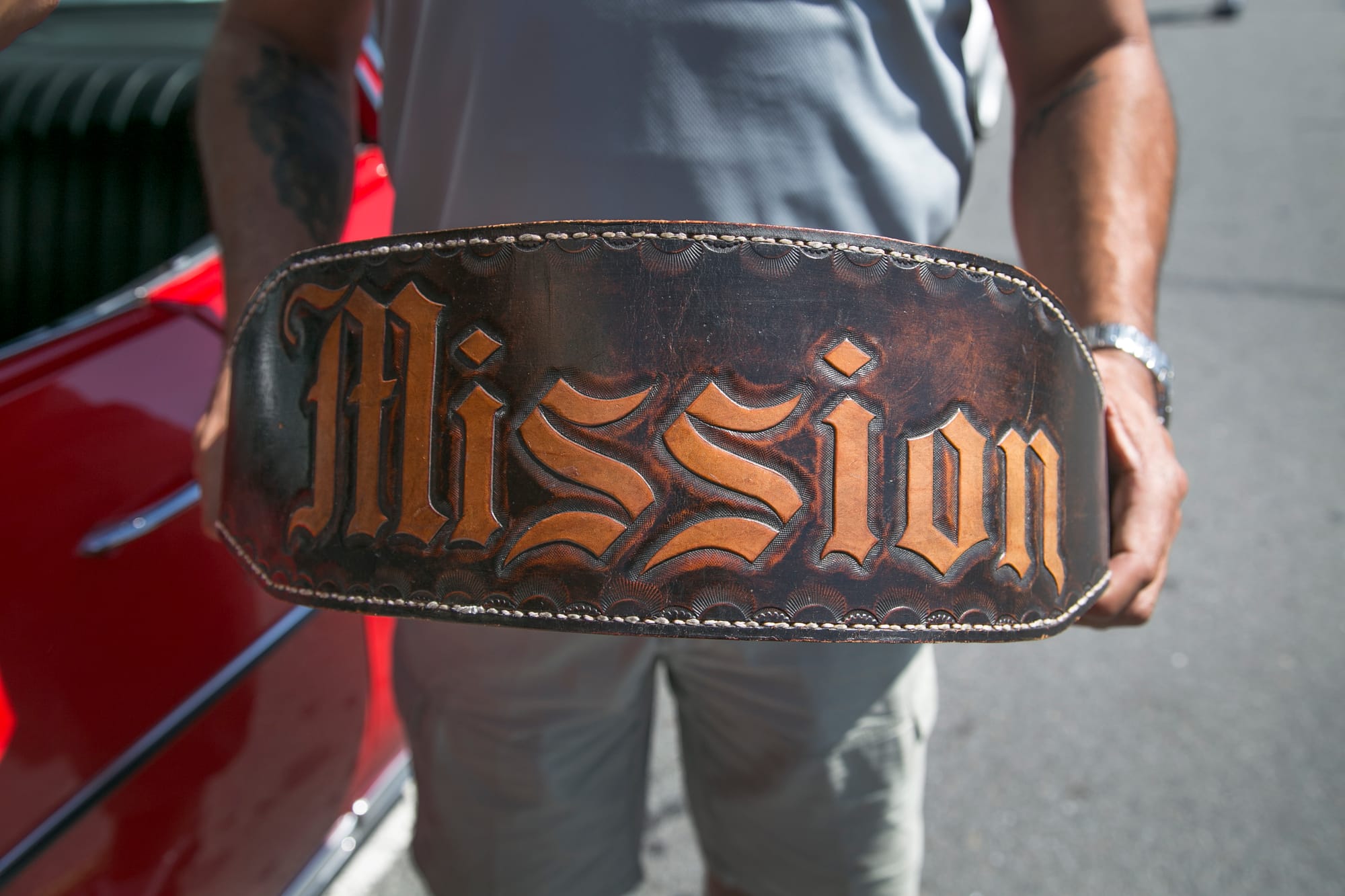 City College English professor Benjamin Bac Sierra holds his brother's etched-weight belt from his time in prison during the 1980s. His brother graduated from City College and encouraged Bac Sierra to enroll. Bac Sierra bought his first lowrider car when he received tenure at City College. (All photos by Gabriella Angotti-Jones/The Guardsman)Jones).