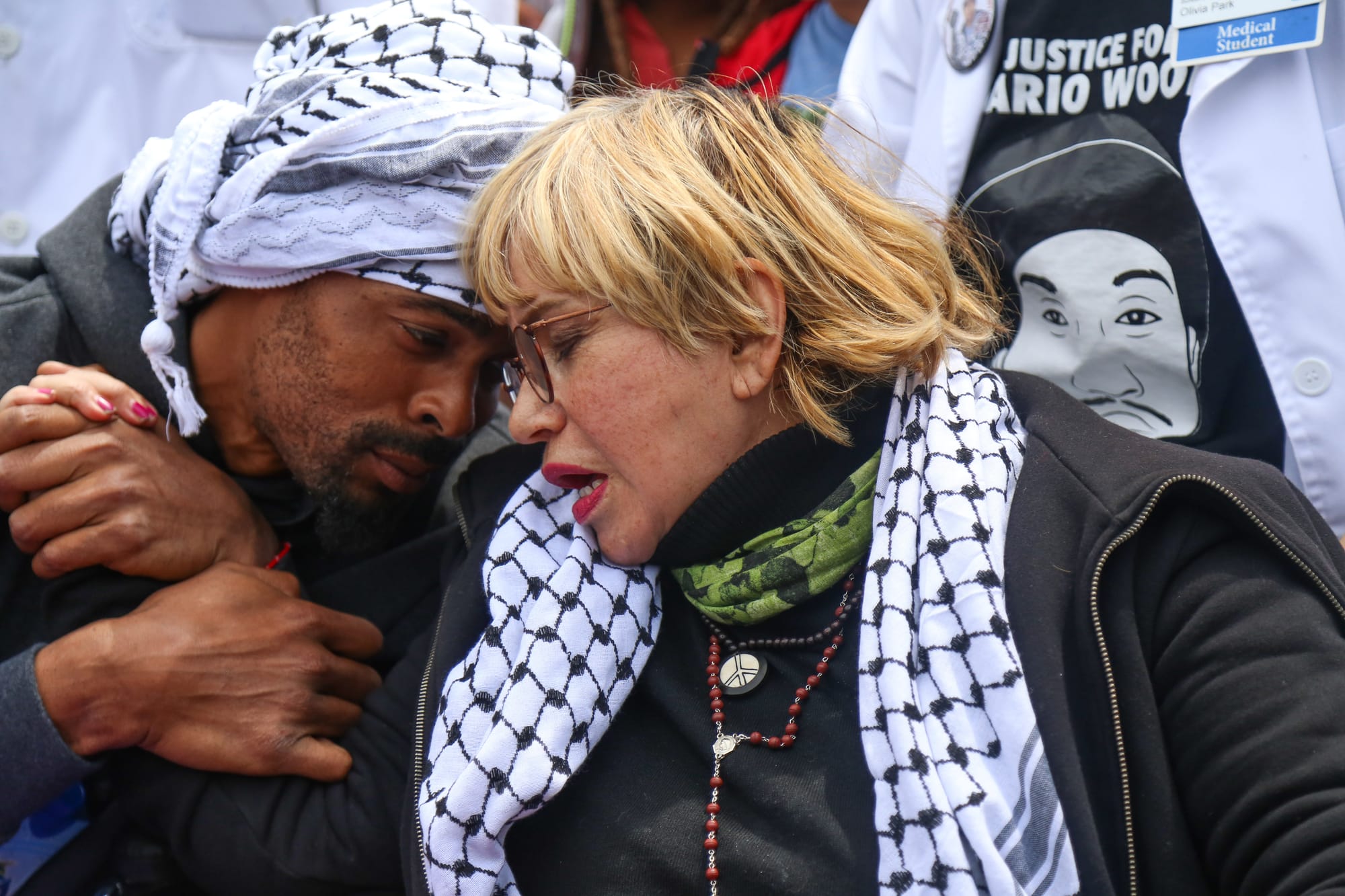 Sellassie, left, and Gutierrez, right, embrace in a hug while being pushed in wheelchairs on their 13th day of being on a hunger strike, during a march against police brutality at City Hall, San Francisco on Tues. May 3, 2016, (Photo by Natasha Dangond/Special to The Guardsman)