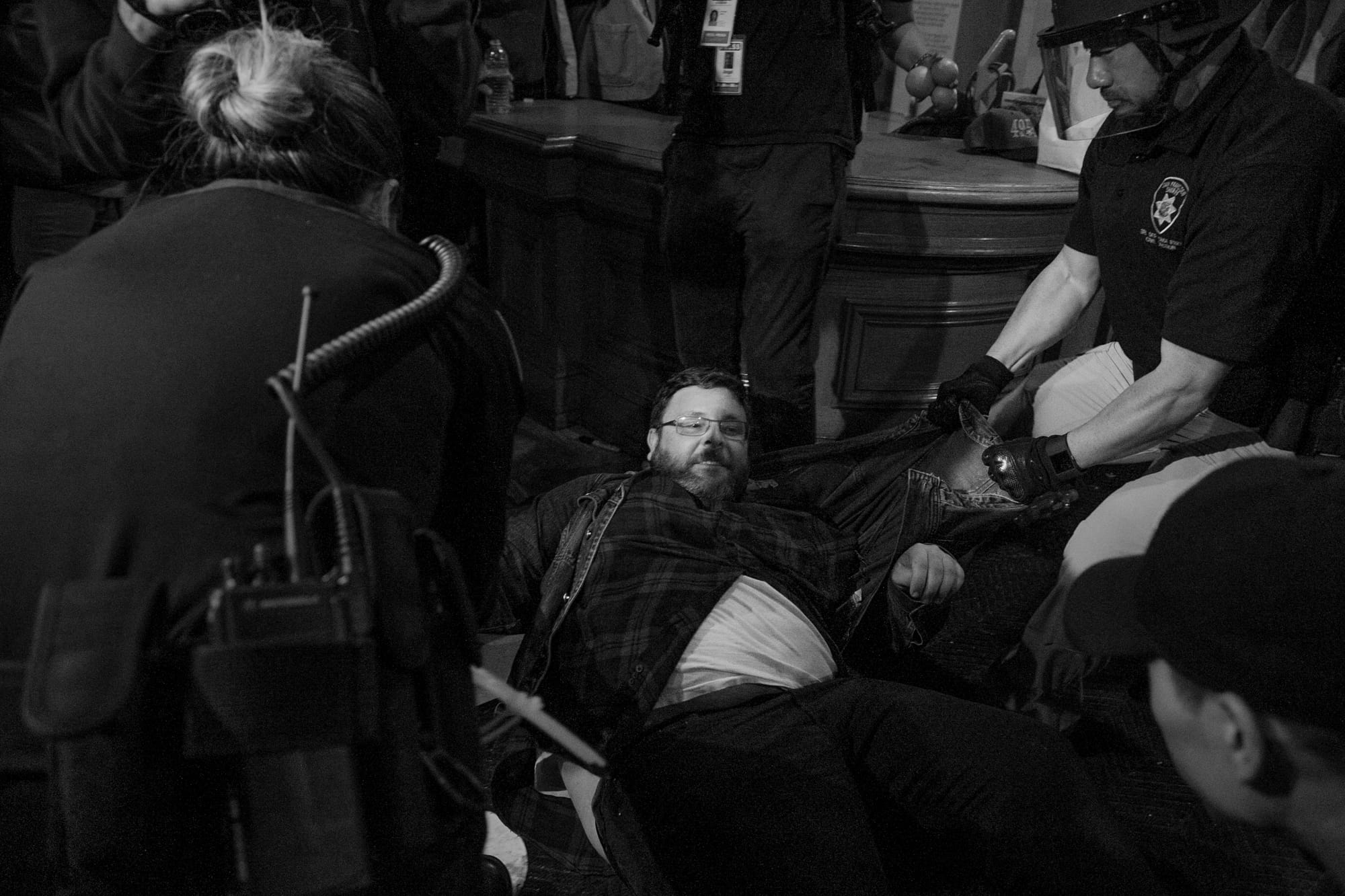 A protester is arrested and dragged across the floor during a Hunger for Justice SF after hours occupation of City Hall last night. 33 people were arrested. Protesters demanded action against police brutality and for SFPD Chief Suhr to be fired. (Photo by Gabriella Angotti-Jones)