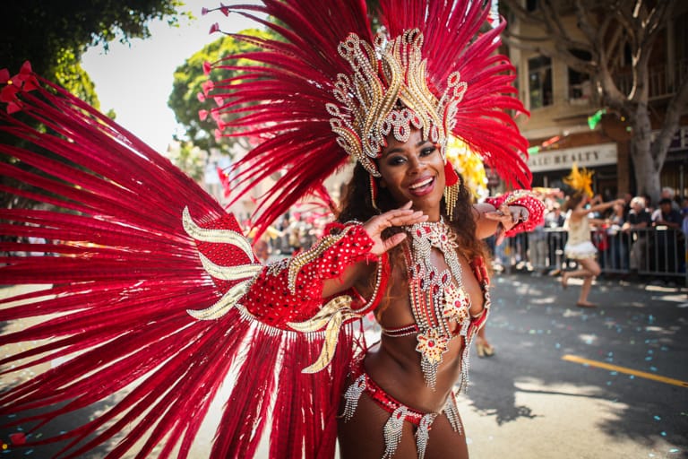 Carnaval performer in costume marches in the 38th Annual Carnaval San Francisco grand parade on 24th Street in San Francisco's Mission District during Memorial Day weekend, Sunday, May 29, 2016. (Photo by Ekevara Kitpowsong)