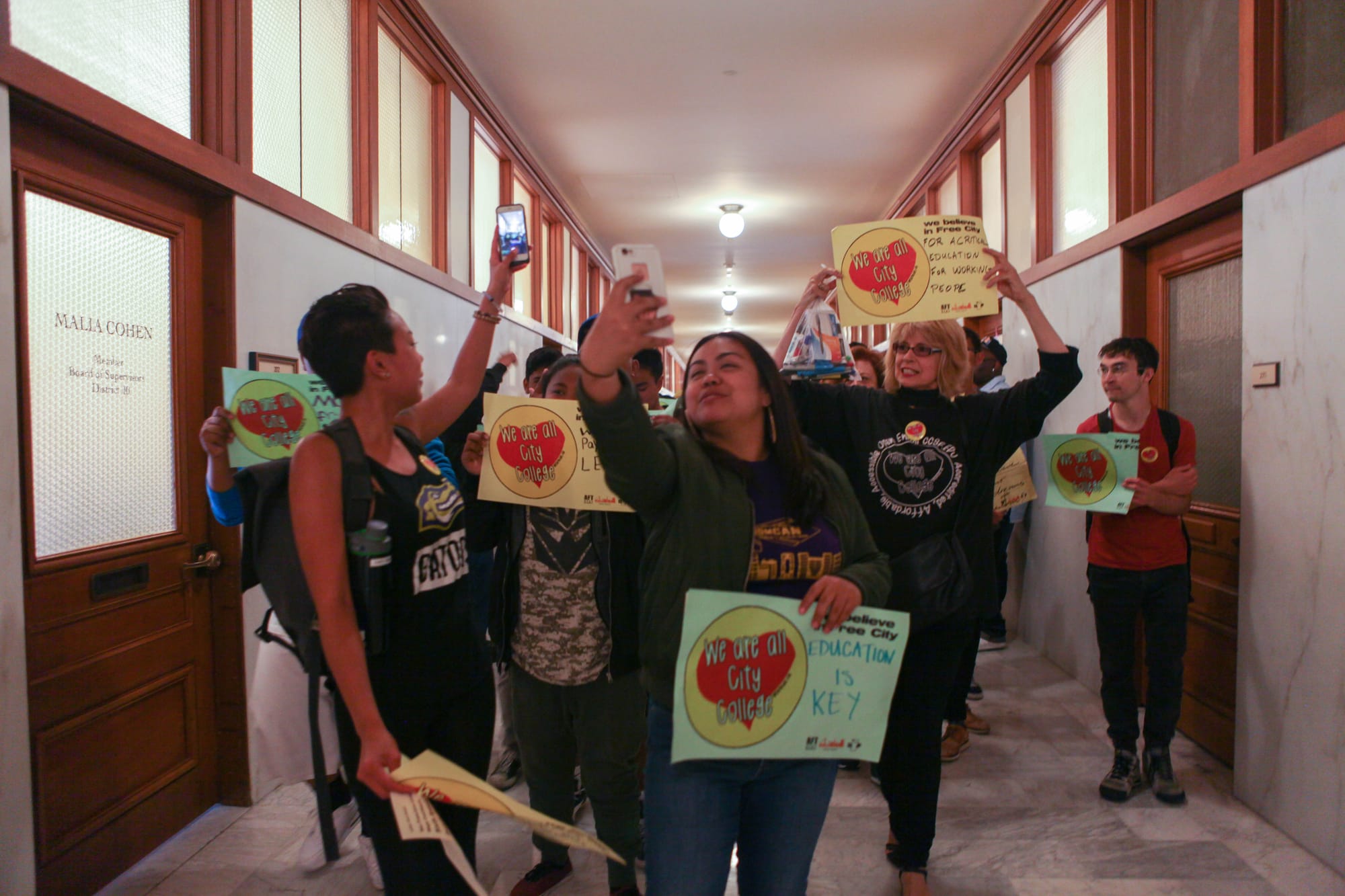 Student supporters Snapchat during their march with AFT members through the Board of Supervisors corridors in San Francisco City Hall on July 12, 2016.