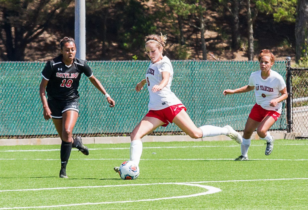 Rams Forward Jesse Bareilles, center, drives the ball for the first point in the match against Skyline College on Aug. 30, 2016. (Photo by Izar Decleto/The Guardsman)
