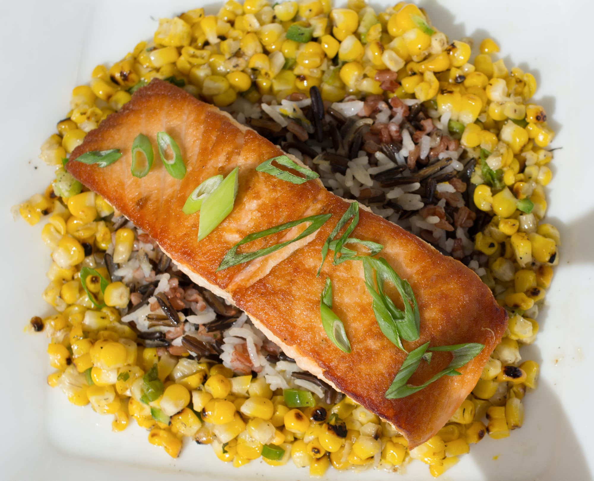 Pan-roasted salmon has hints of lemon balanced with three types of rice and semi-sweet corn salsa (Photo by David Horowitz/The Guardsman)