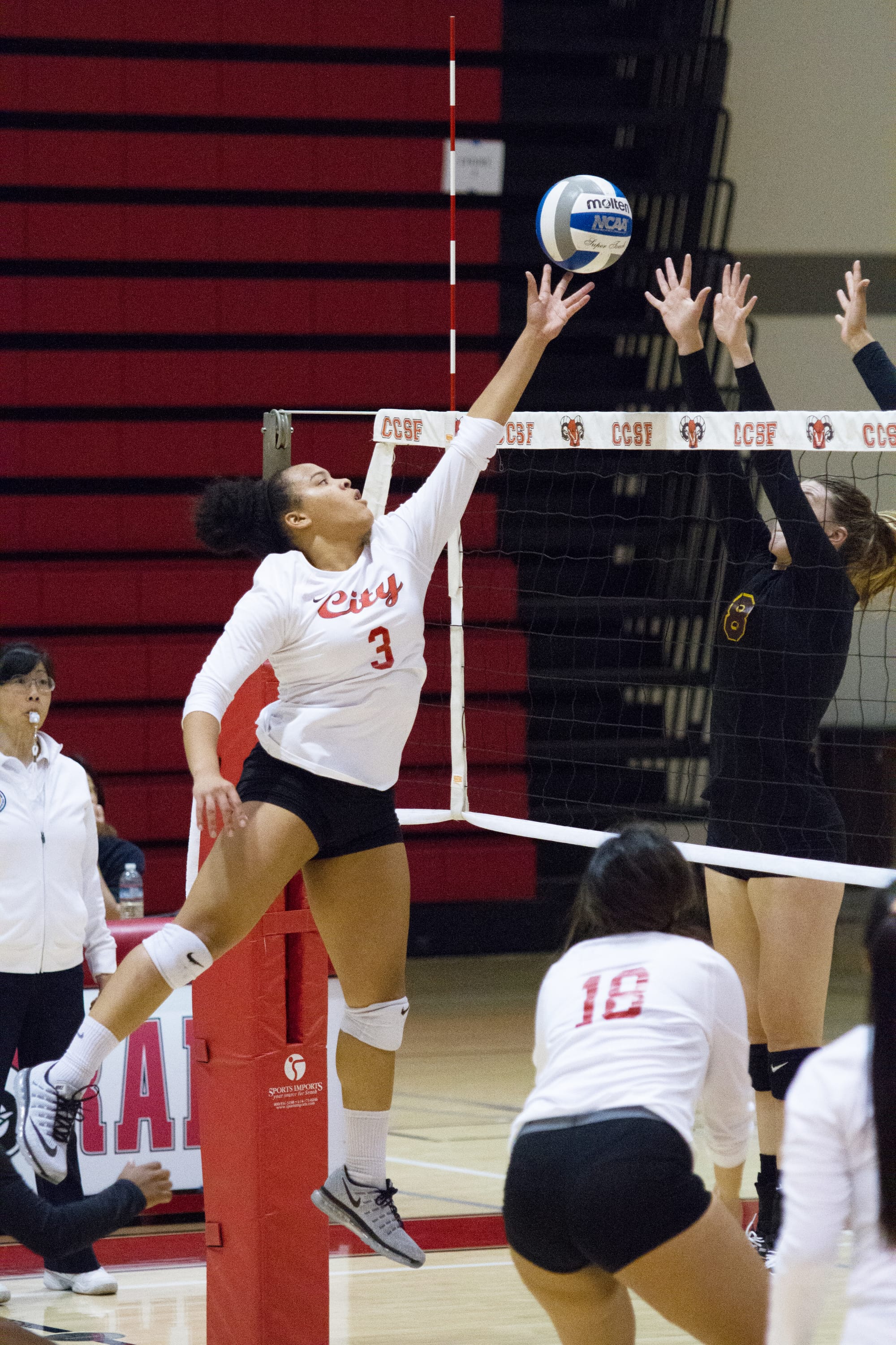 Jennifer Quarters-Styles, outside hitter, seams to be floating as she spikes the ball back to Hartnell College at the Wellness Center at Ocean Campus on October 12, 2016. Photo by Franchon Smith/The Guardsman
