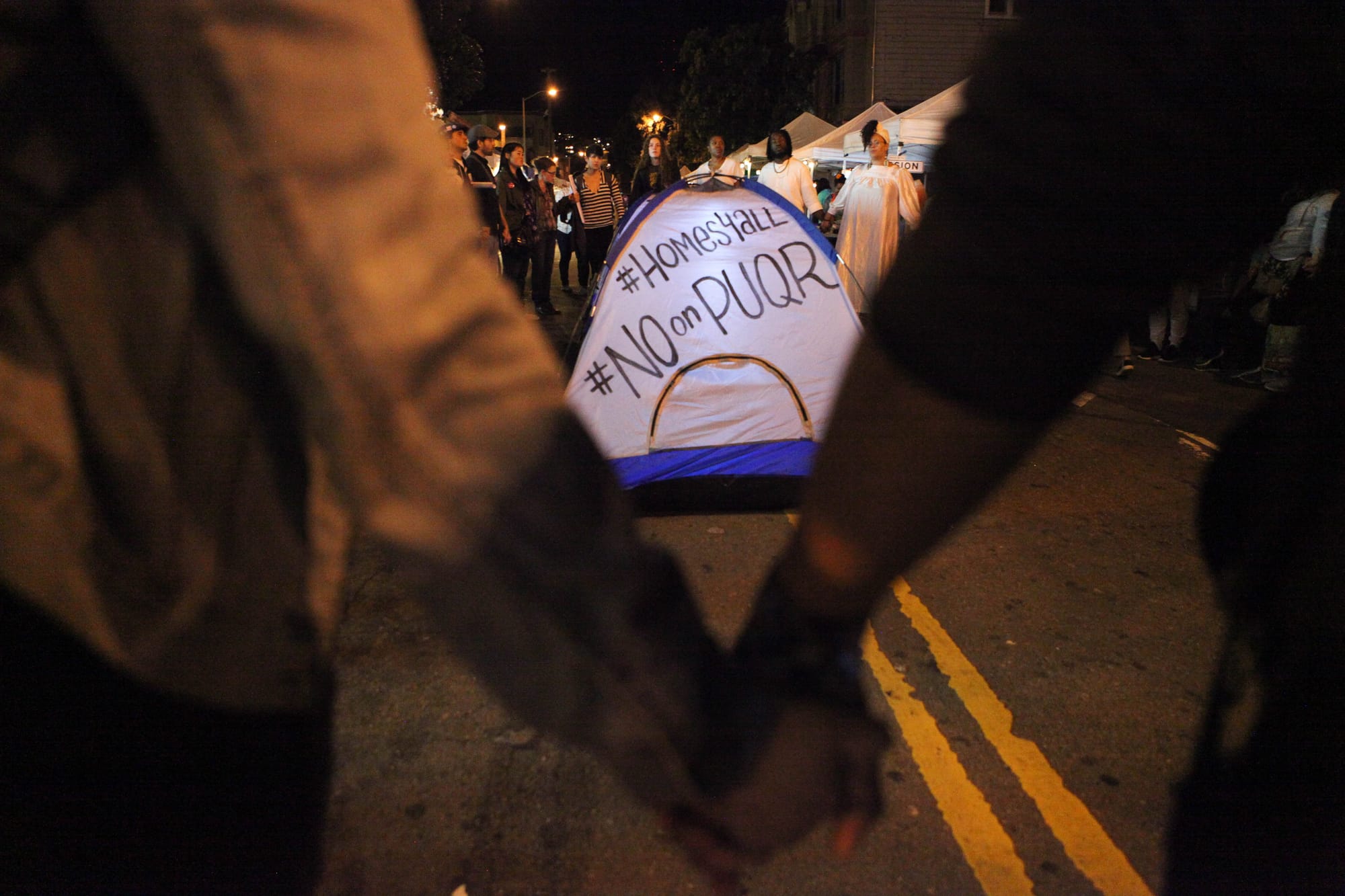 Community organizers hold hands in solidarity to end the march at 22nd Street on Nov. 3, 2016. (Photo by Cassie Ordonio/The Guardsman)