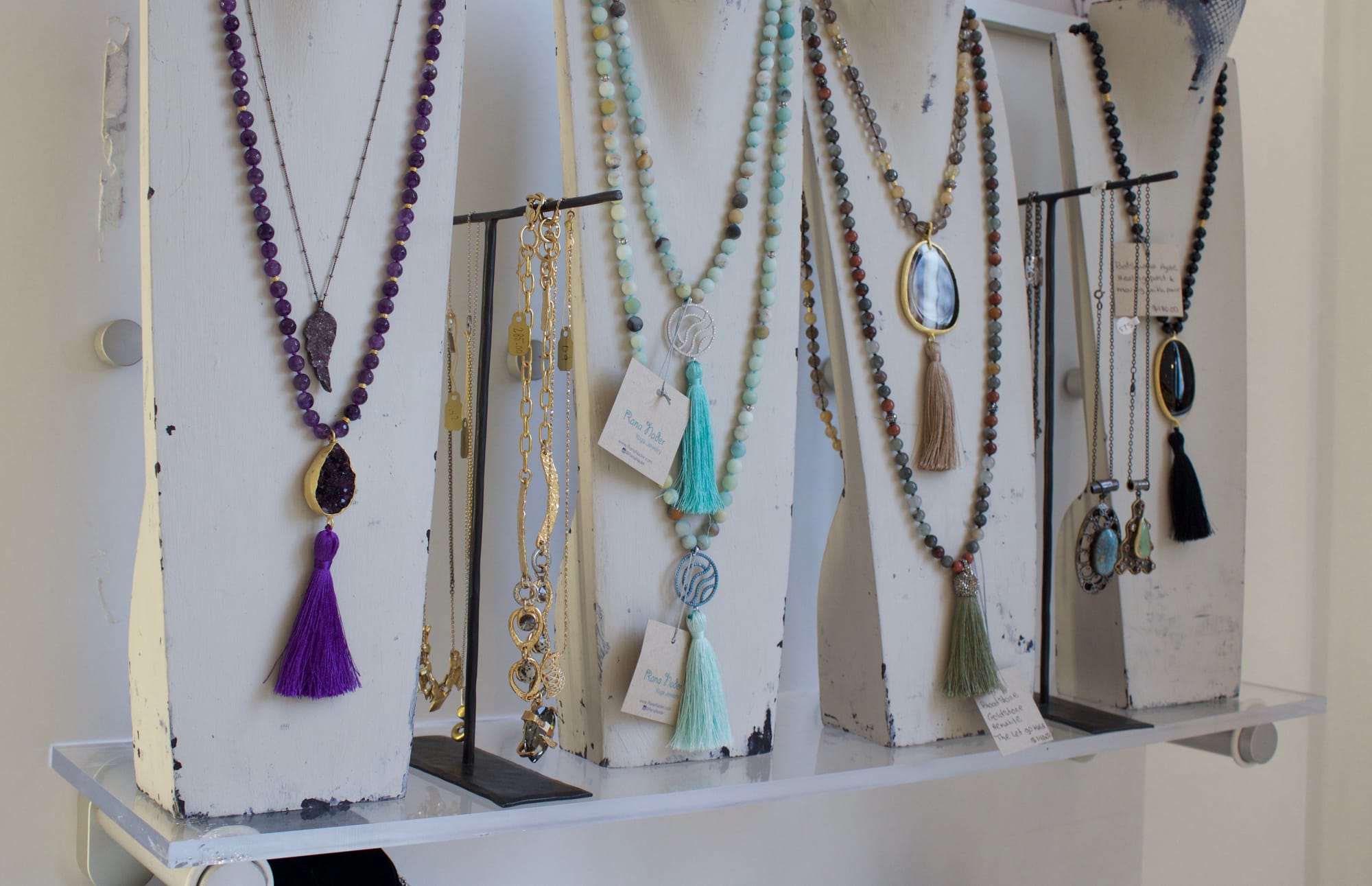 CCSF Fashion student, Sophia Marie, rearranging the visual display at her boutique World Gate Jewelers. Photo by Diana Chuong/ The Guardsman