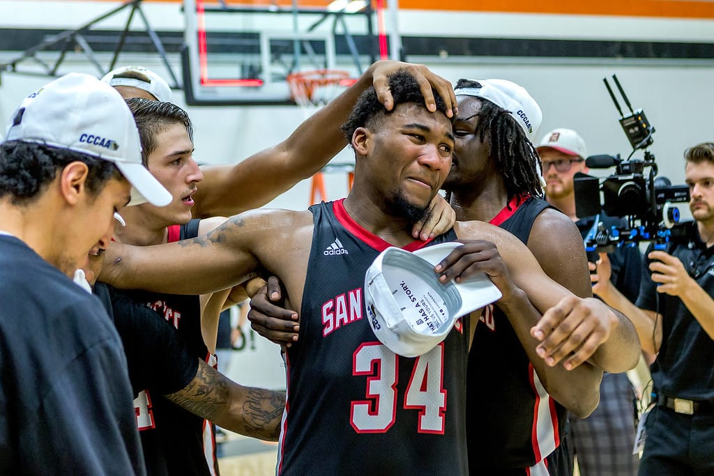 Sophomore forward Lewis Hayes (#34) is cheered on by teammates after receiving the CCCAA tournament MVP trophy.  Photo by Peter Wong/Special to The Guardsman.