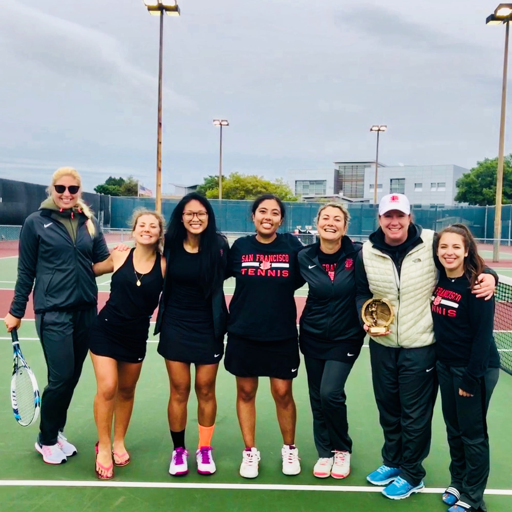 (L-R) Caroline Olander, Claudia Houdre, Yvonne Ng, Abigail Campos, Zee Aynaci, Coach Hickey, Aliza Sandberg after advancing to the Nor-Cal Conference Tournament and receiving Conference Co-Coach of the year. Photo courtesy of CCSF Athletics Department.