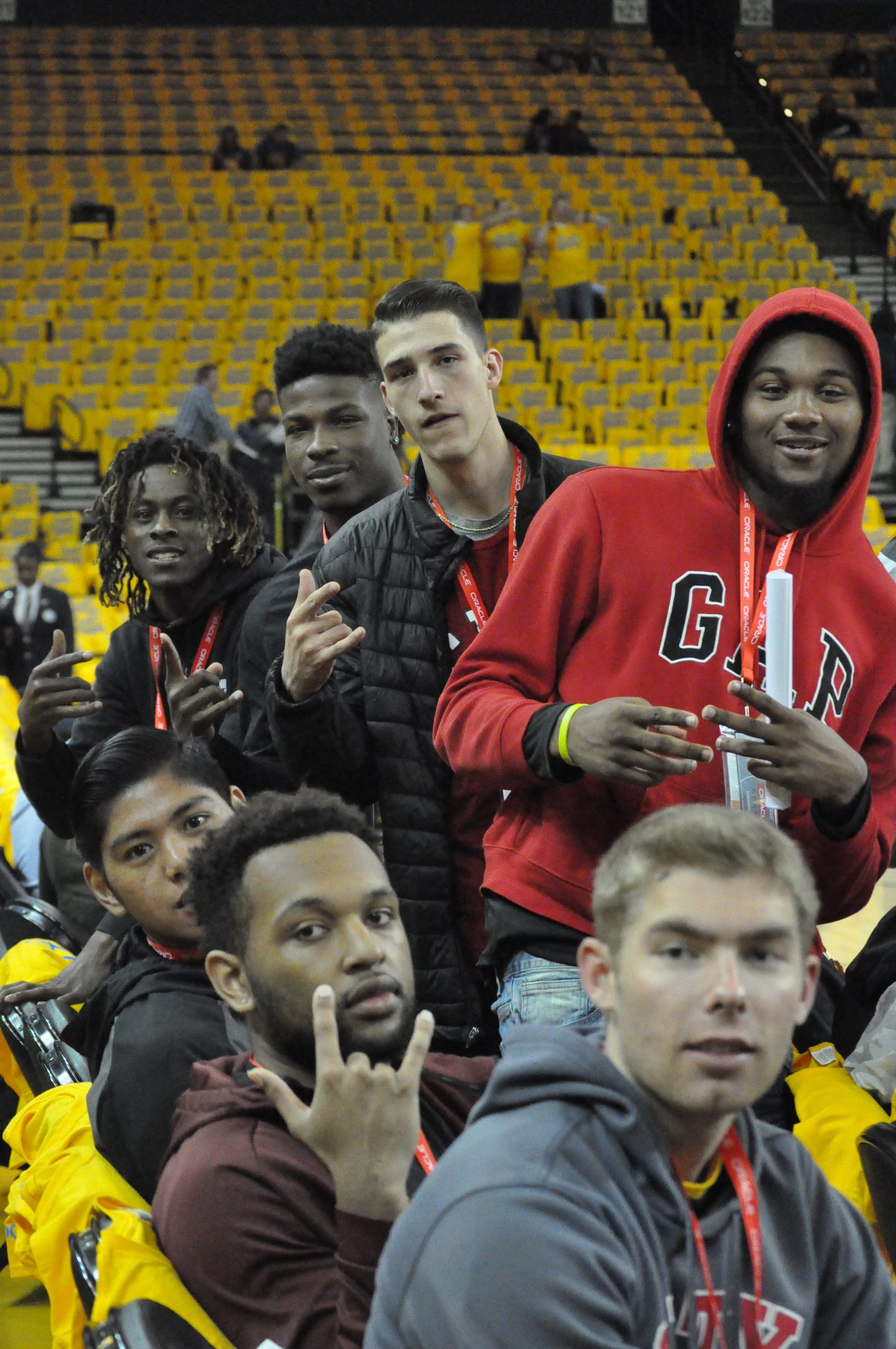 Rams players Curtis Witt, front to back, Austin Harris, Ben Borja, Lewis Hayes, Eddy Ionescu, Dexter Hood, and Terrell Brown sitting court-side during warmups at the Warriors vs Spurs Game 2 NBA playoff on April 16, 2018.  Photo by Peter J. Suter/The Guardsman.