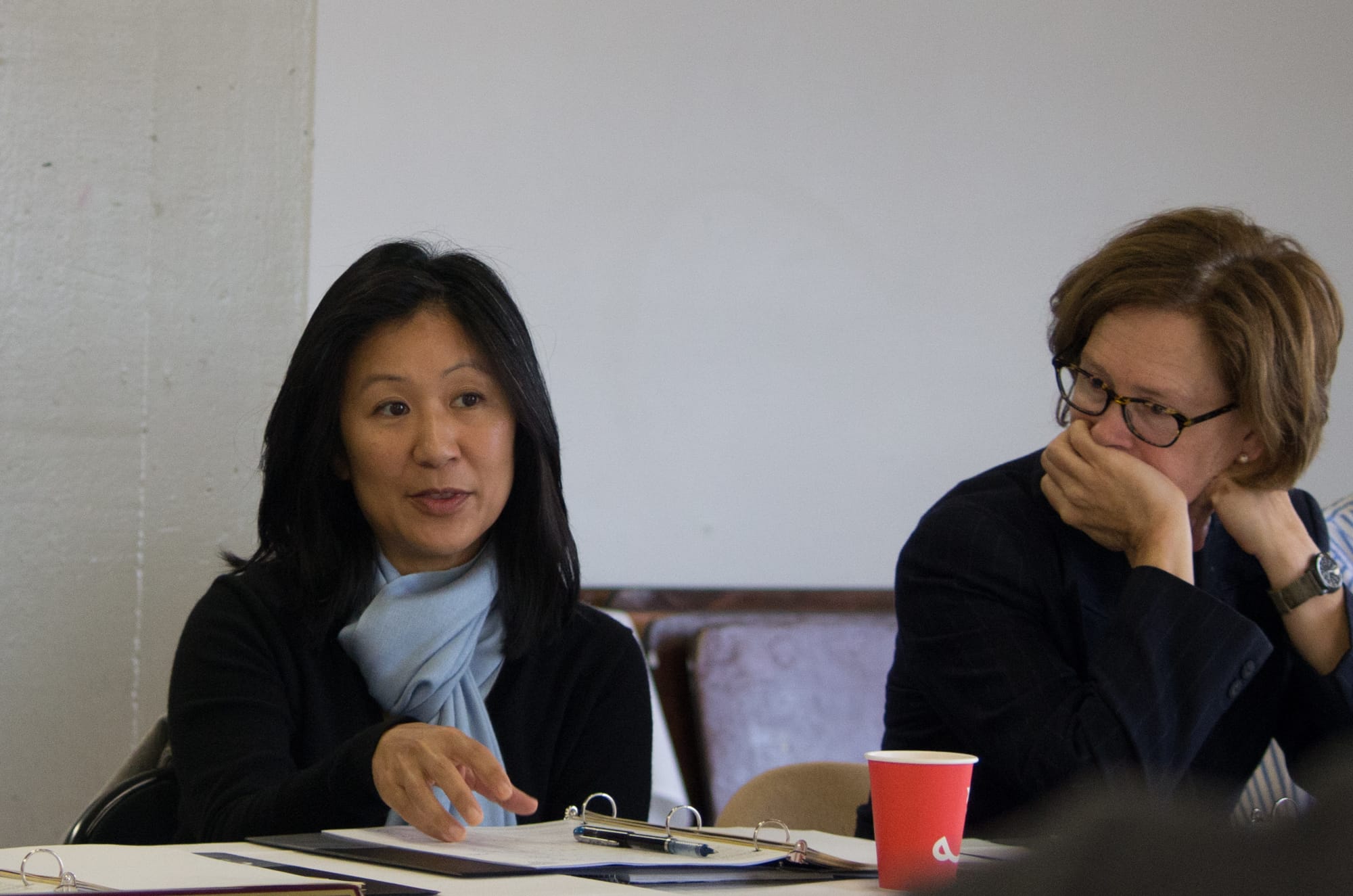 City College Trustee Ivy Lee, left, engages her colleagues in discussion at a board retreat as Trustee Thea Selby, right, listens in on Aug. 10 at the college’s Fort Mason Center. (David Mamaril Horowitz / The Guardsman)