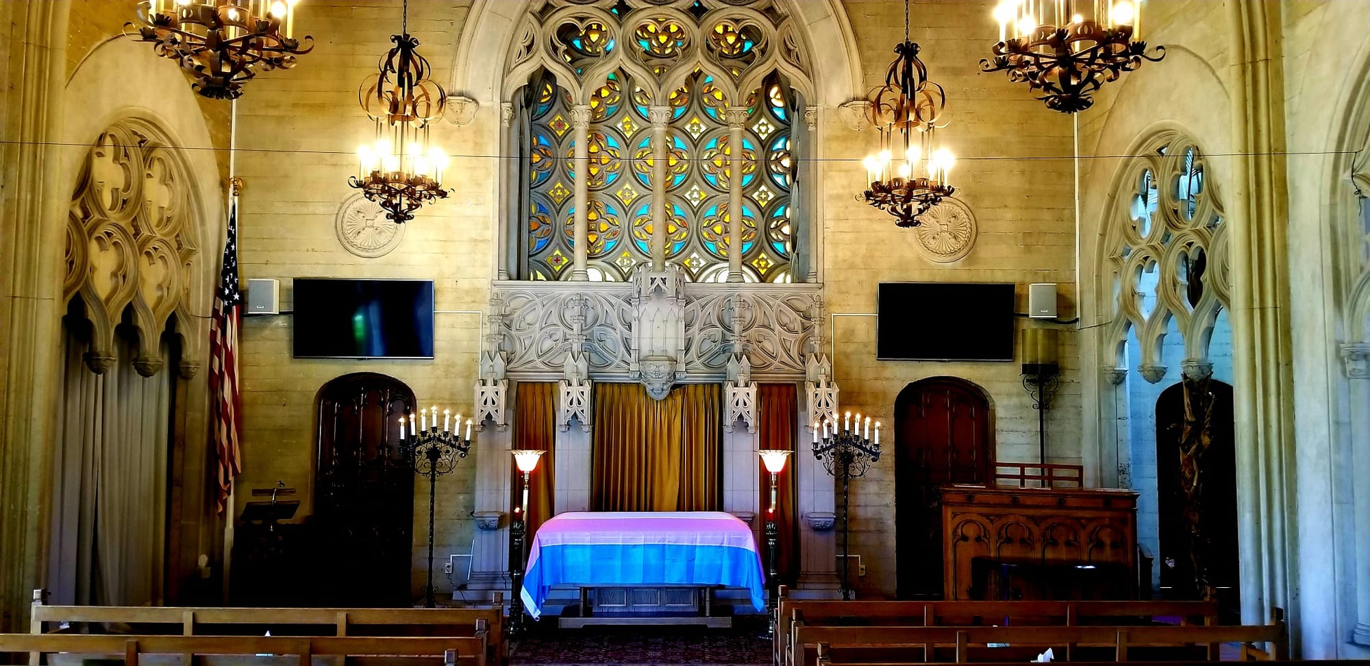 The transgender flag covers the casket of the late Daine Faolan Grey at Oakland's Chapel of the Chimes on July 26, 2018. Photo courtesy of Lady Katerina.
