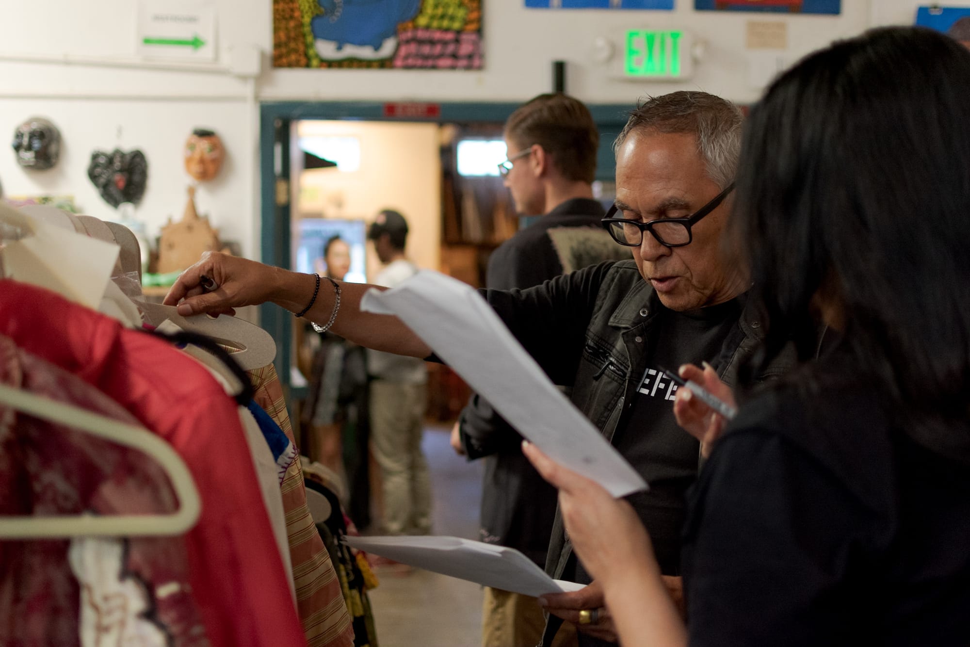Stylists, Nelson Bloncourt and Mariel Gonzalez run through their list of articles on the clothesline yet to be assigned to a model. Thursday, Sept. 20, 2018. Photo by Cliff Fernandes/The Guardsman Download permissions Viewers can download